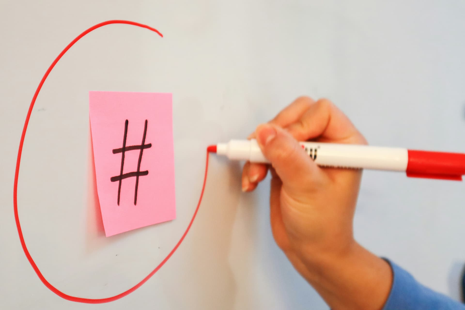 Social media hashtag strategy and digital marketing concept - Person writing hashtag strategies